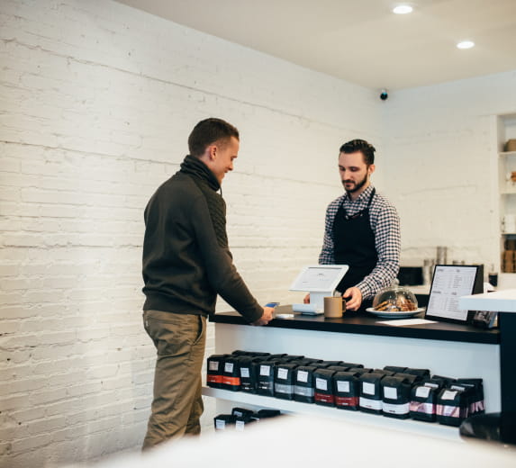 Employee interacting with a customer at a checkout counter